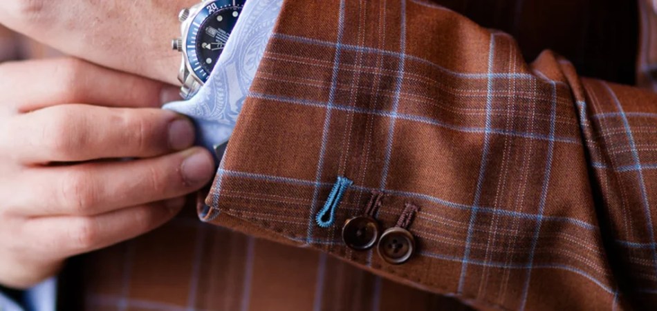 Hand-finished jacket cuff with working buttons and contrast stitching